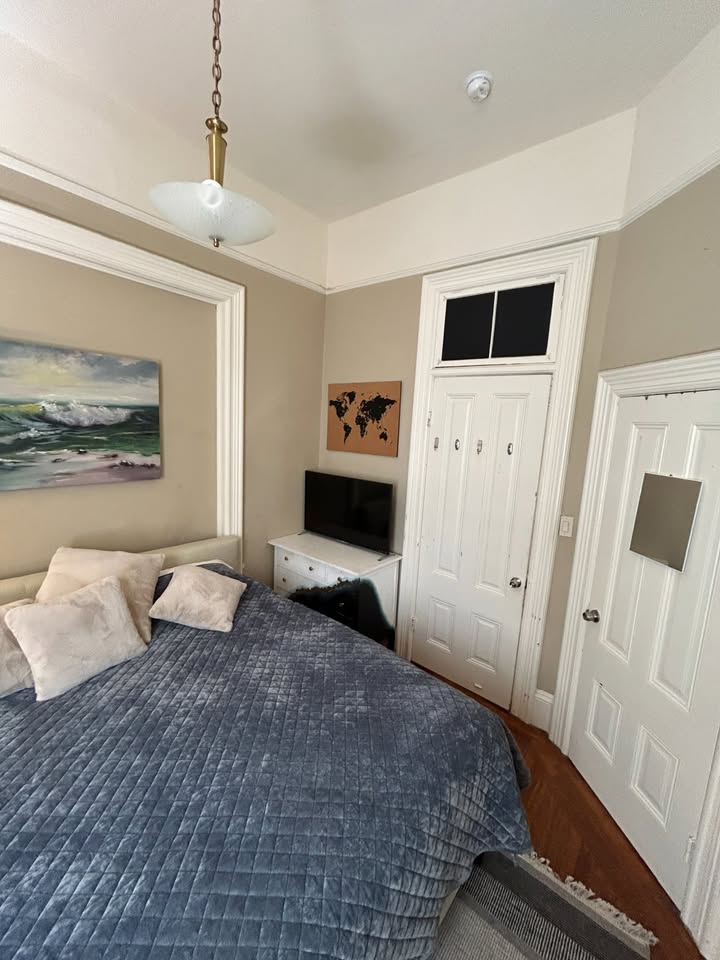 Bedroom with ocean art and closet doors