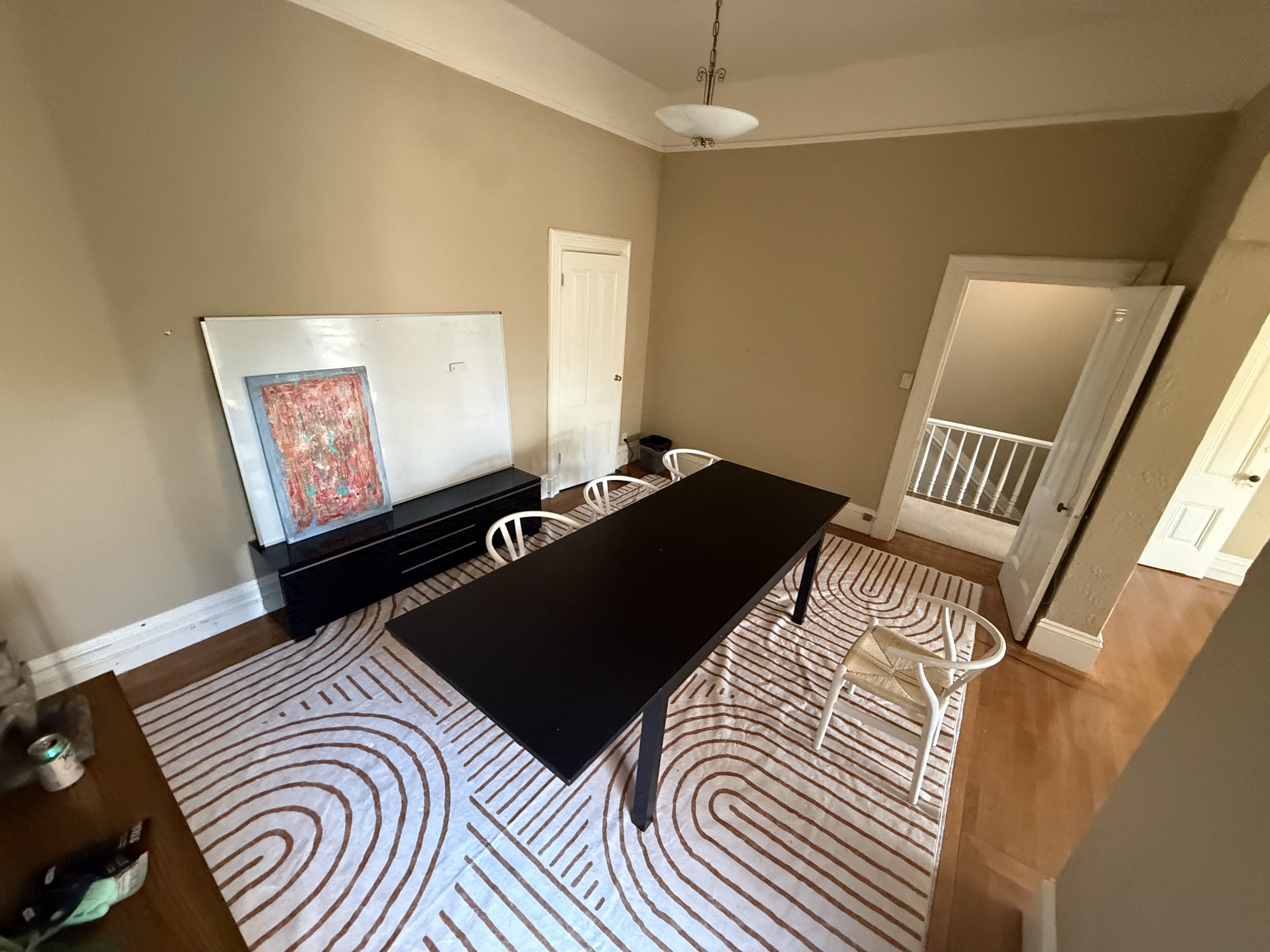 Conference room with black table and whiteboard