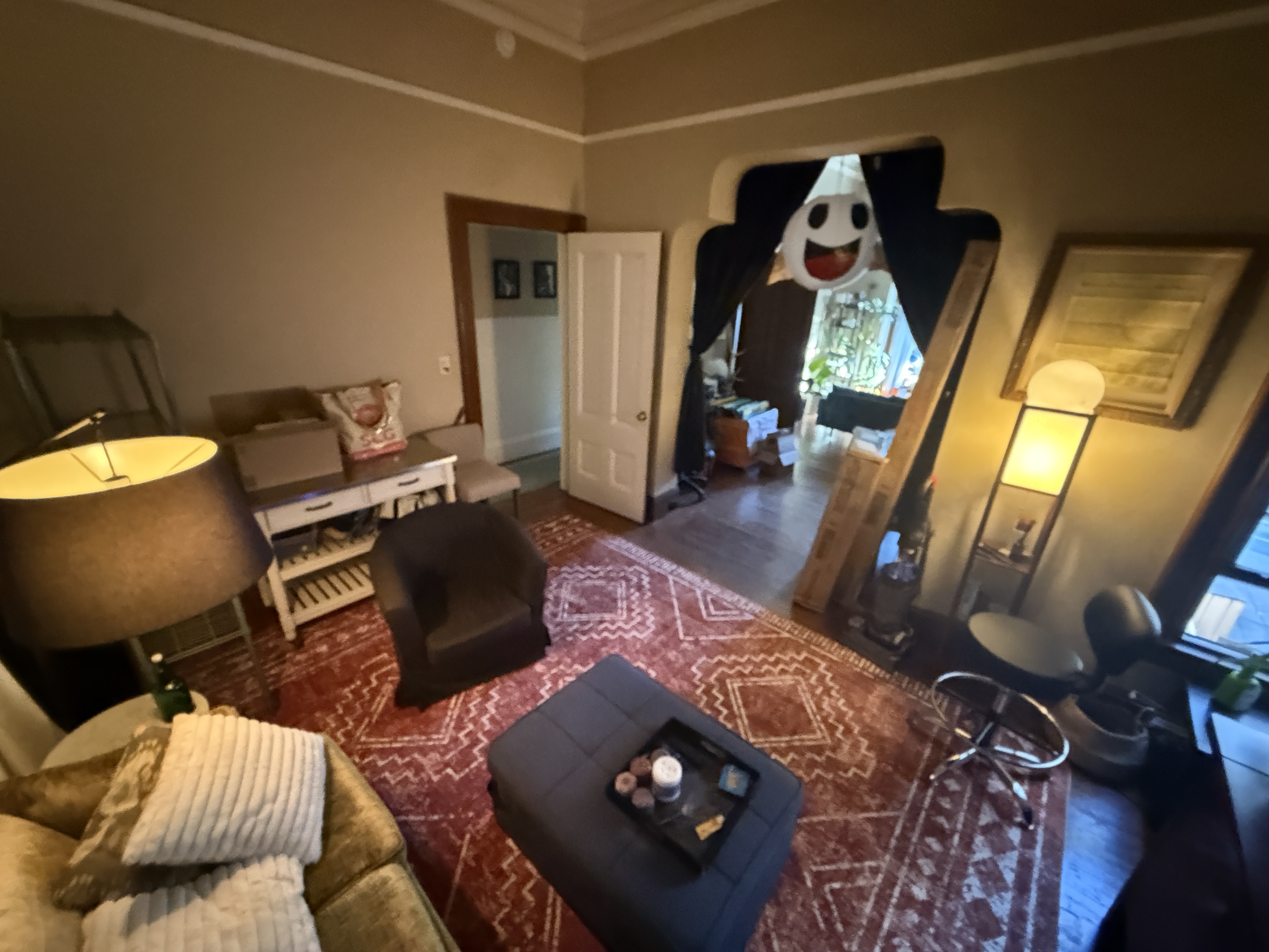 Living room with vintage velvet sofa and ghost decoration