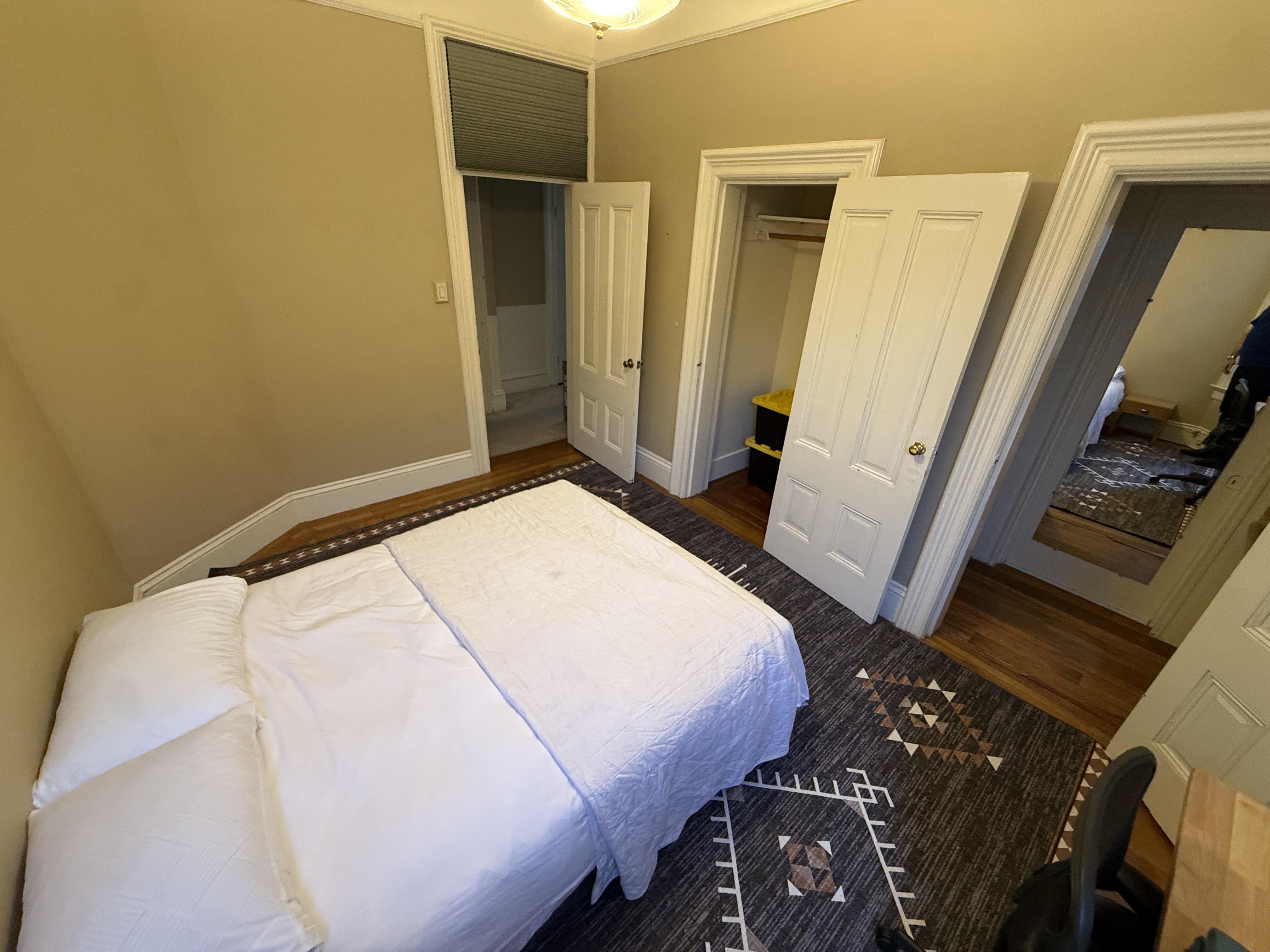 Bedroom with open closet and multiple doorways