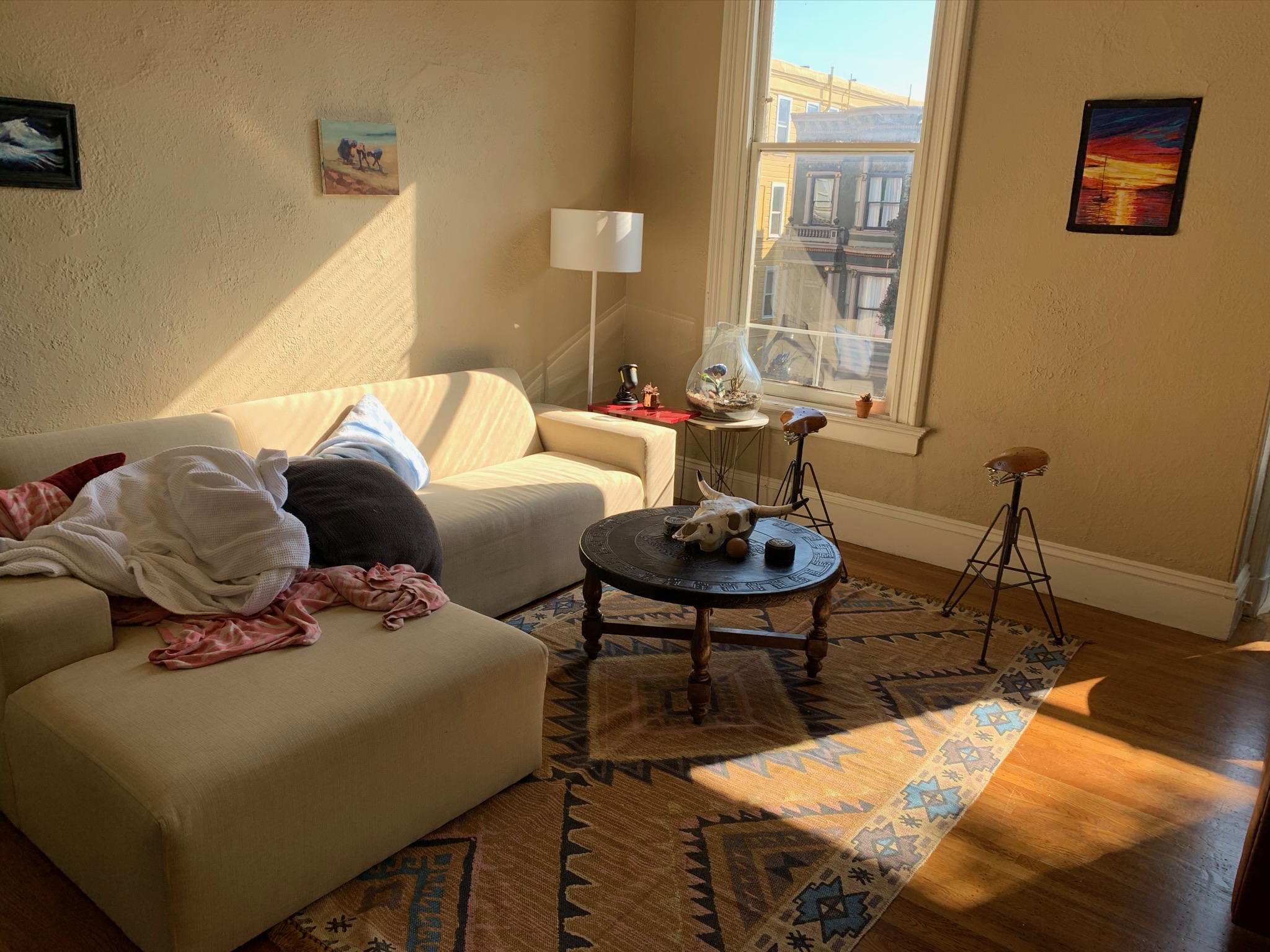 Bright room with white sectional and large windows